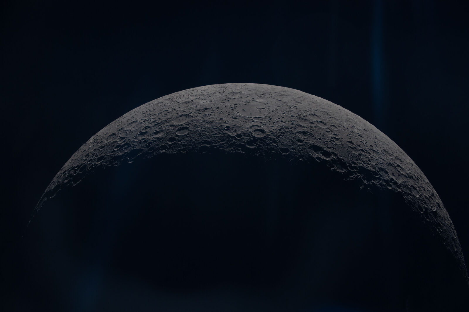 The curved grey limb of the Moon's far side, photographed up close by the Artemis II crew from the Orion spacecraft