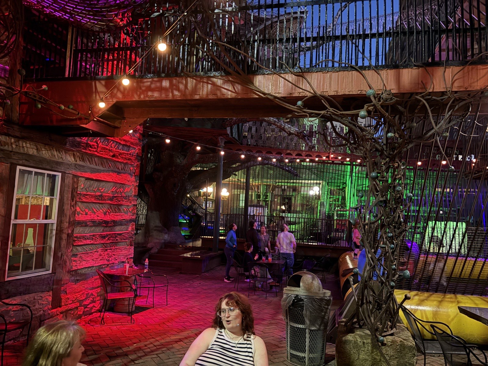An outdoor play and gathering area at City Museum with climbing structures and open sky
