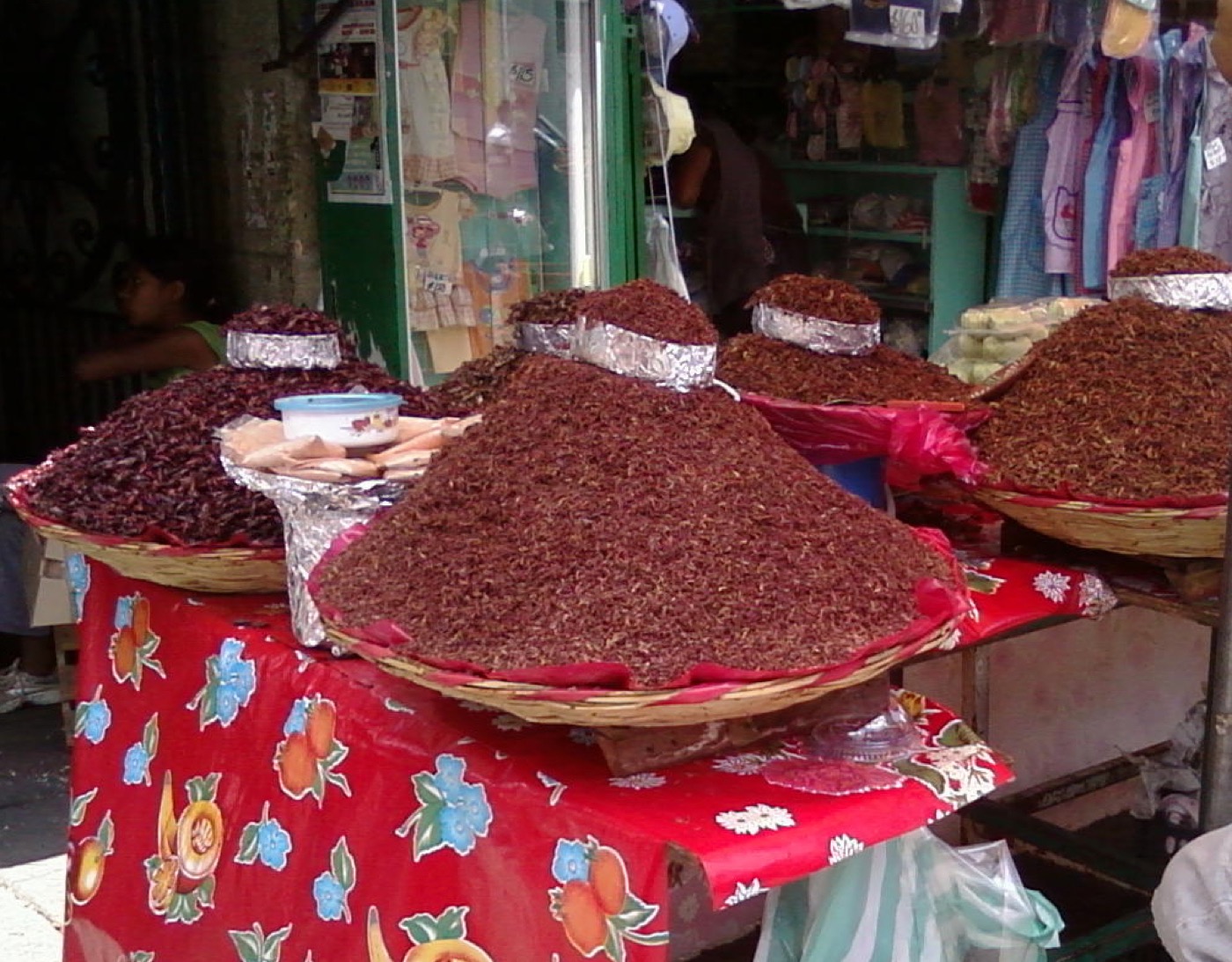 A pile of chapulines — small toasted grasshoppers seasoned red with chili and lime — as sold in Oaxaca, Mexico