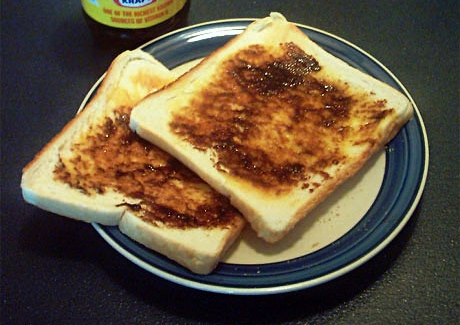 Vegemite spread thinly on buttered toast, the dark brown Australian yeast-extract spread