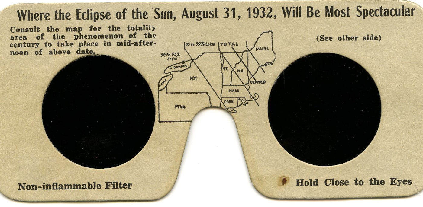 Cardboard eclipse glasses printed with a small map of the northeastern United States between the lenses, headed 'Where the Eclipse of the Sun, August 31, 1932, Will Be Most Spectacular'