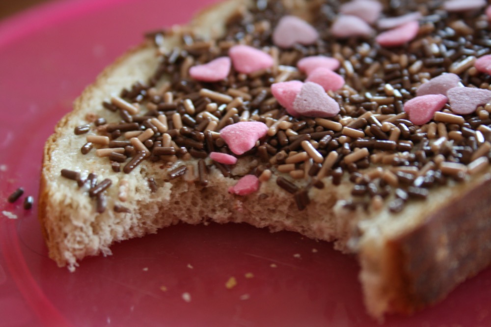 Fairy bread decorated with extra candy hearts among the rainbow sprinkles
