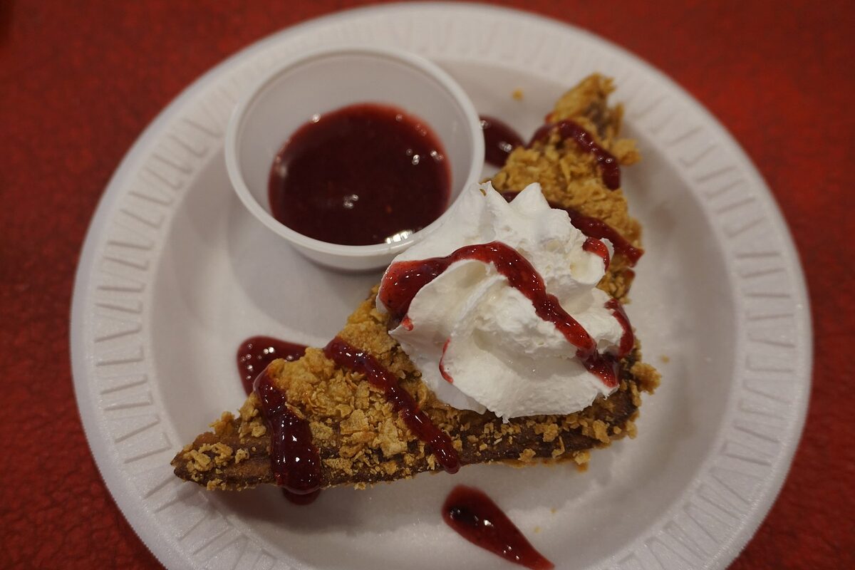 A plate of deep-fried Nutella custard stuffed French toast at the State Fair of Texas, with whipped cream and berry sauce