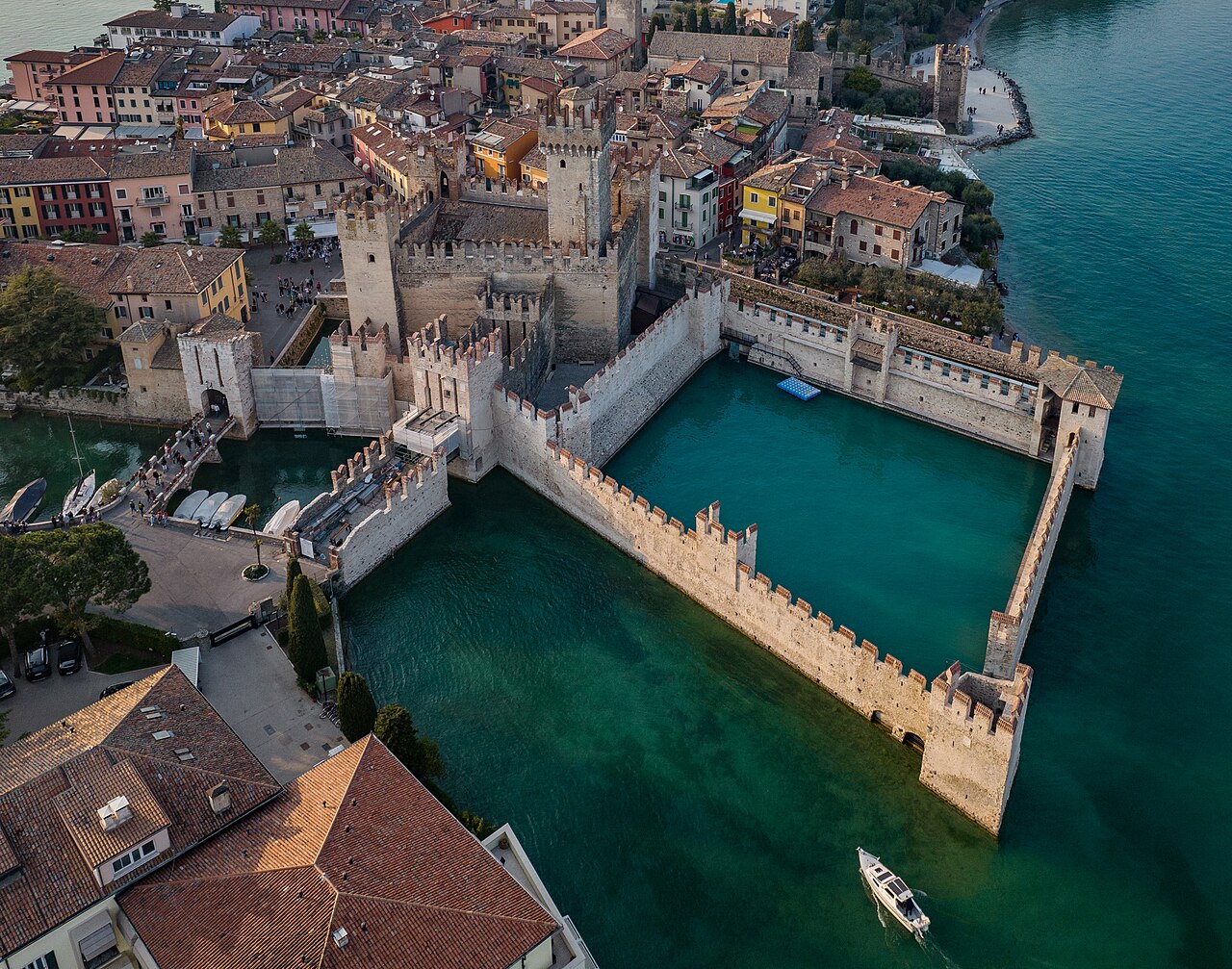 The Scaligero Castle at Sirmione, a medieval fortress with swallowtail battlements surrounded by lake water