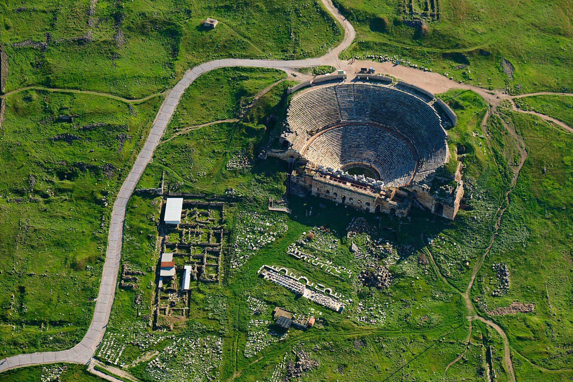The large stone amphitheatre of ancient Hierapolis above Pamukkale, with tiered seating cut into the hillside
