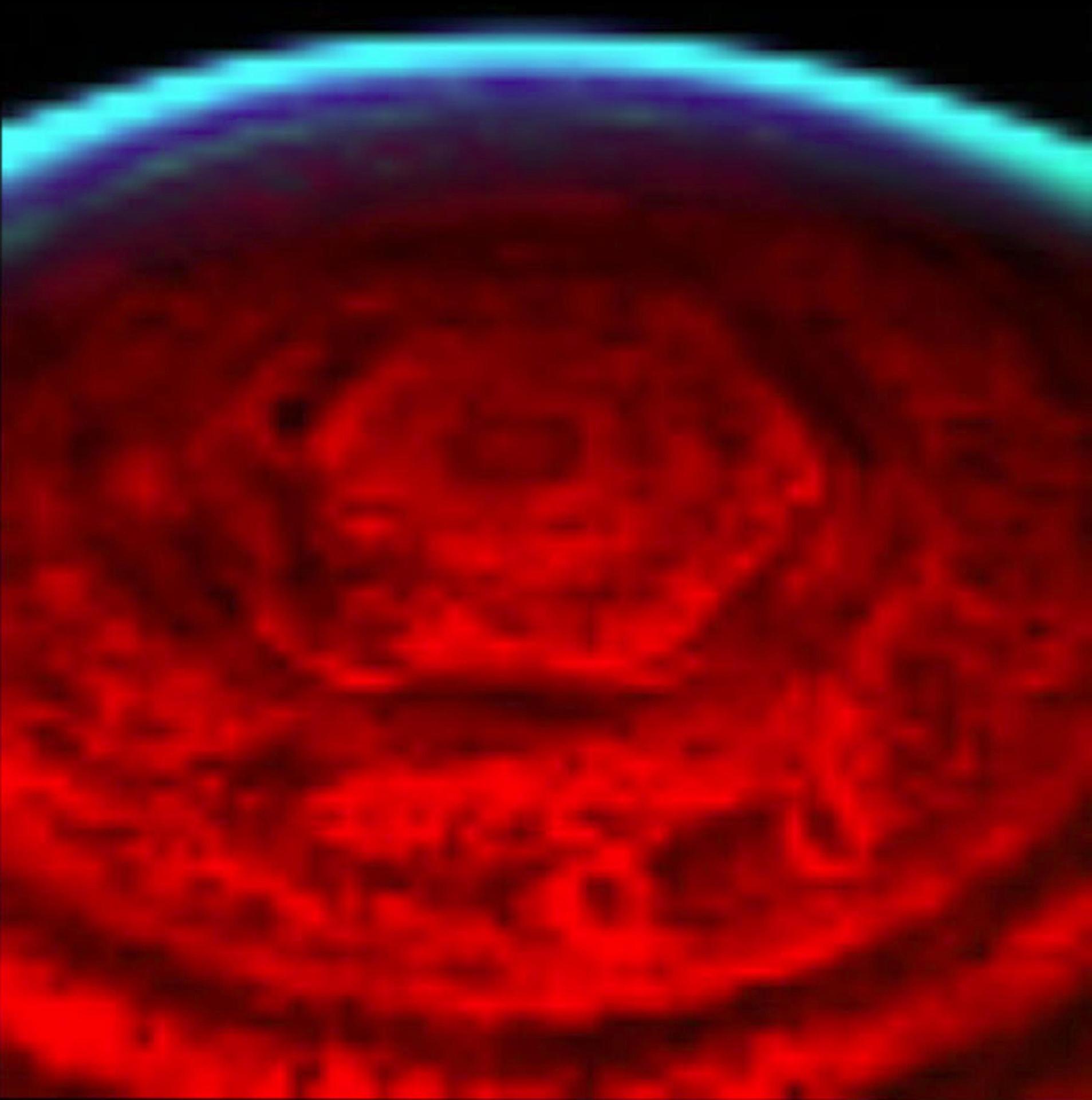 An early Cassini infrared view of Saturn's north pole showing the six-sided hexagon glowing against the dark polar night