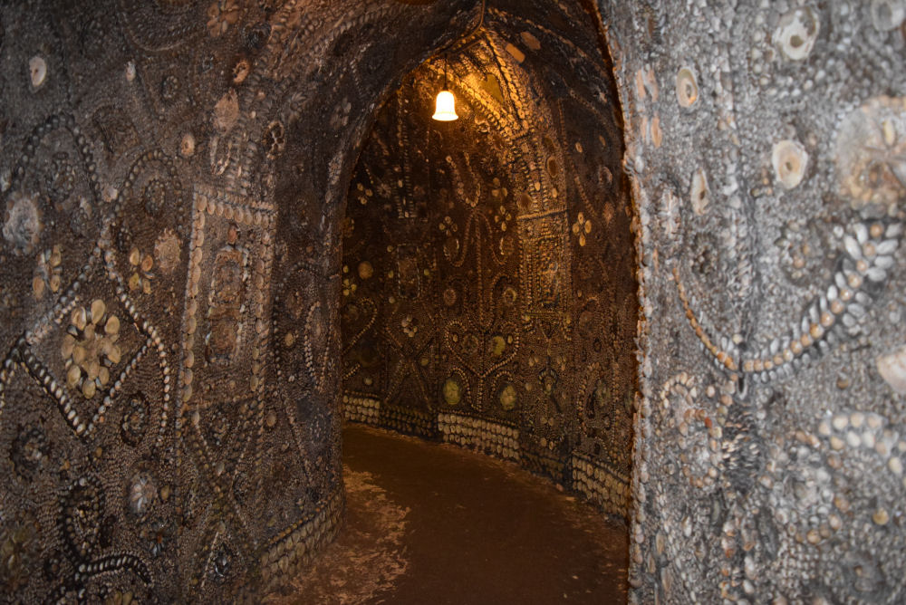 The winding Serpentine Passage of the Shell Grotto, shell mosaics on both walls curving into the dark