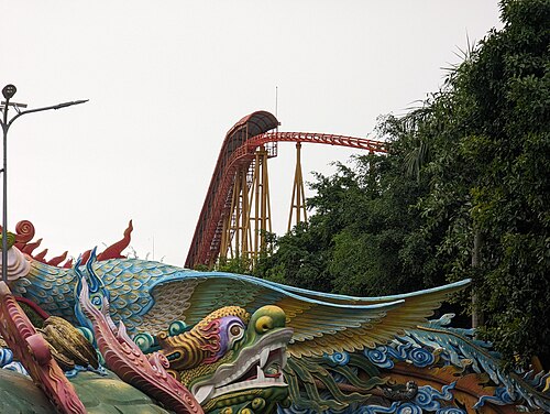 A dragon-themed rollercoaster snaking over water at Suoi Tien